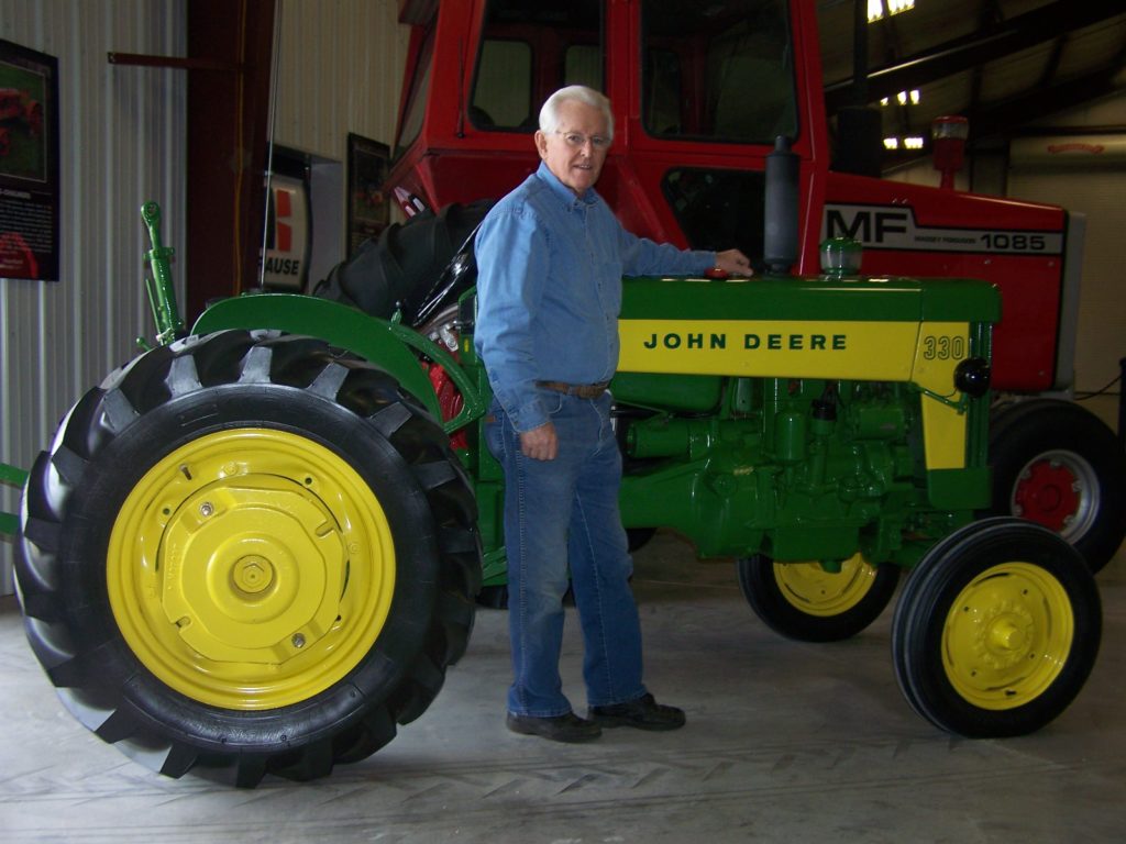 John Cannon next to tractor